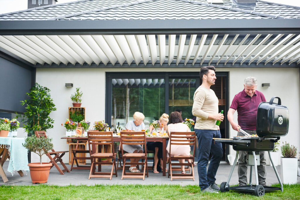 two men barbecuing on patio at family lunch 2025 04 04 12 22 42 utc