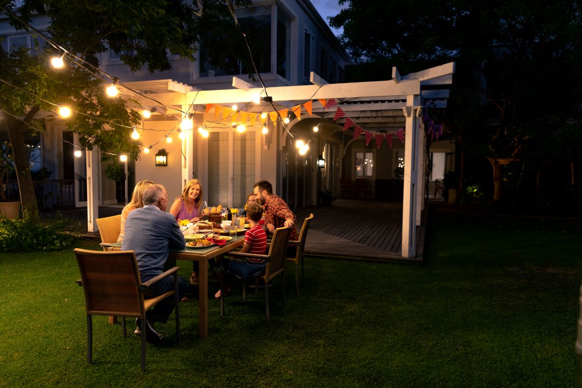 family outside enjoying pergola