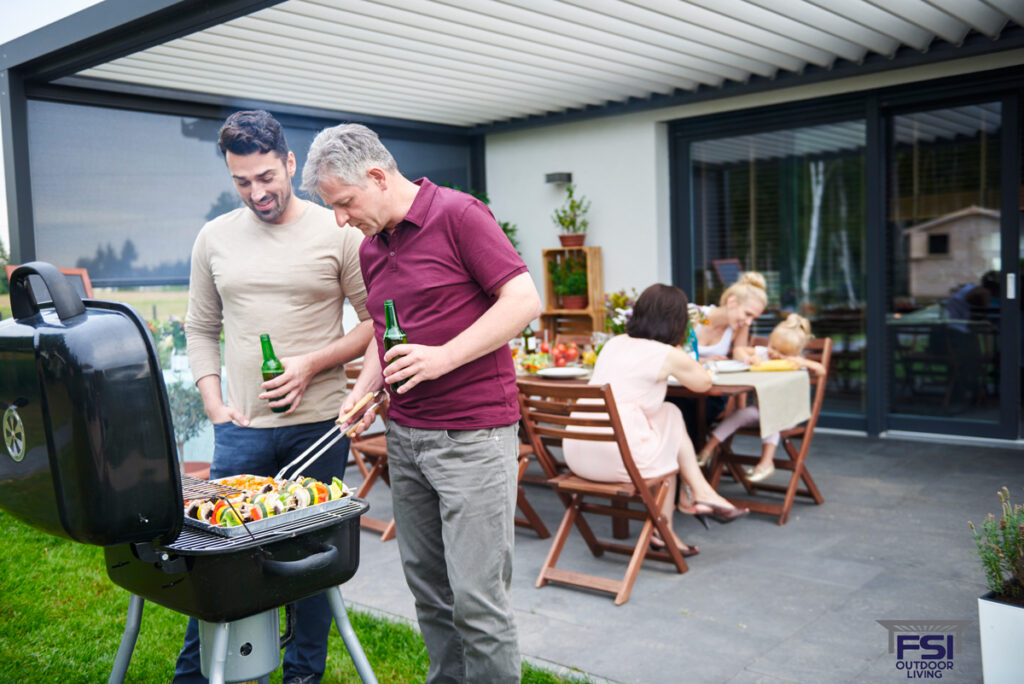 How Bellevue Families Are Creating All-Season Outdoor Spaces with Retractable Pergola Covers mature and mid adult man barbecuing at family lunc 2025 04 03 23 06 51 utc